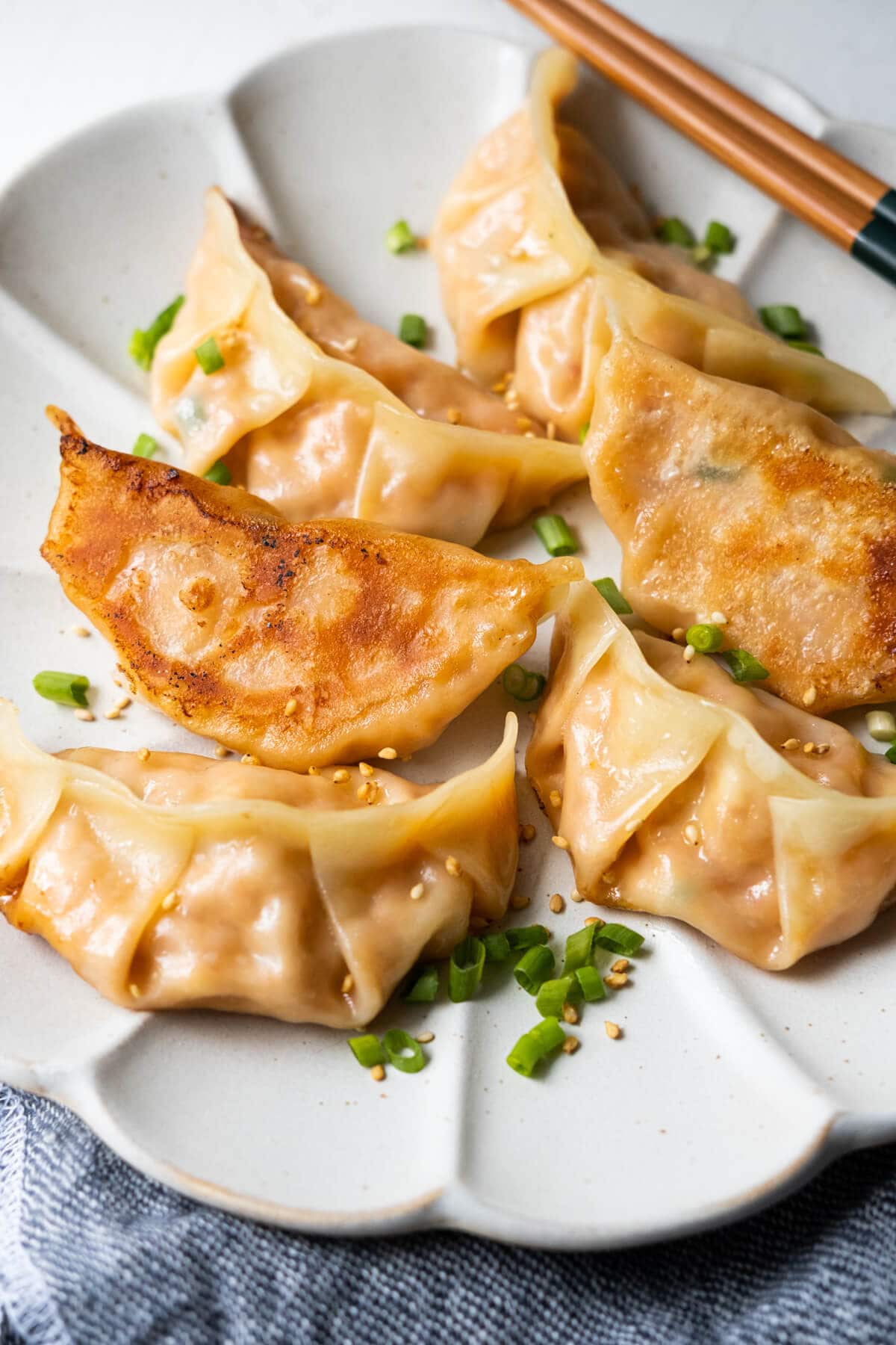 Pan-fried mandu with a golden brown crispy dumpling wrap. 