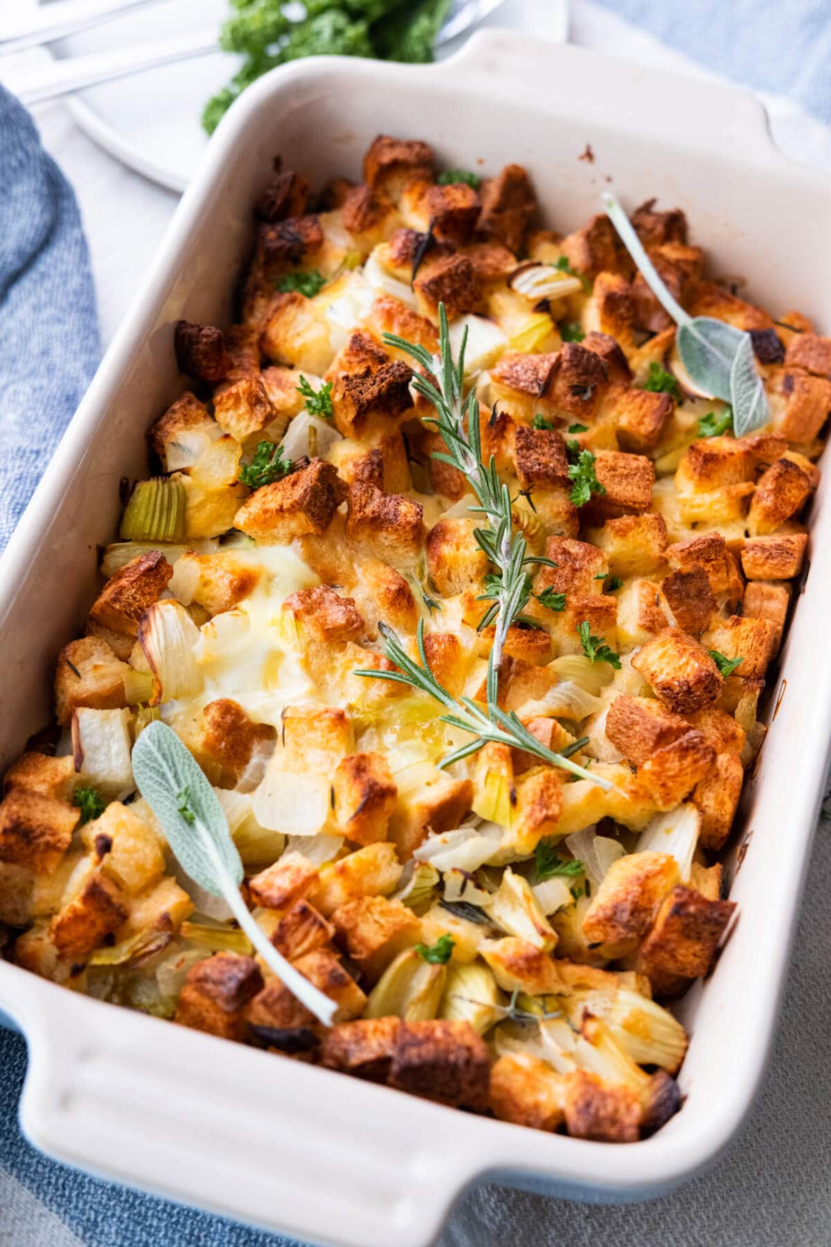 Golden brown stuffing recipe served in a rectangular baking dish. 