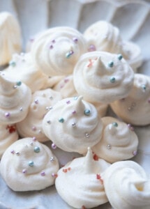 Easy and quick vanilla meringue cookies served on a white plate.