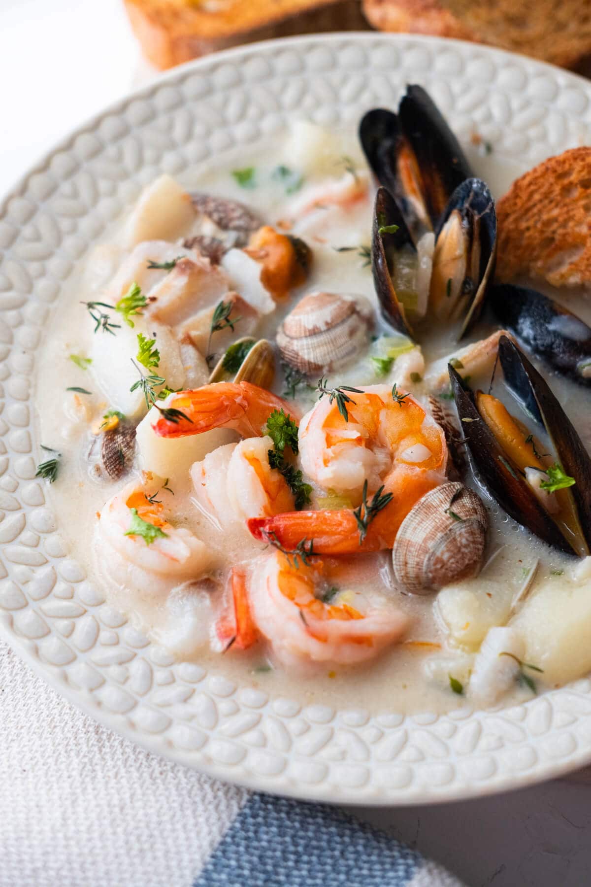 Seafood chowder overloaded with clams, mussels, prawns, and tender potatoes.