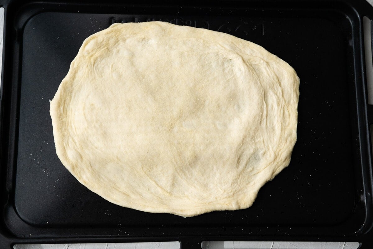 Place the shaped dough onto a baking sheet. 