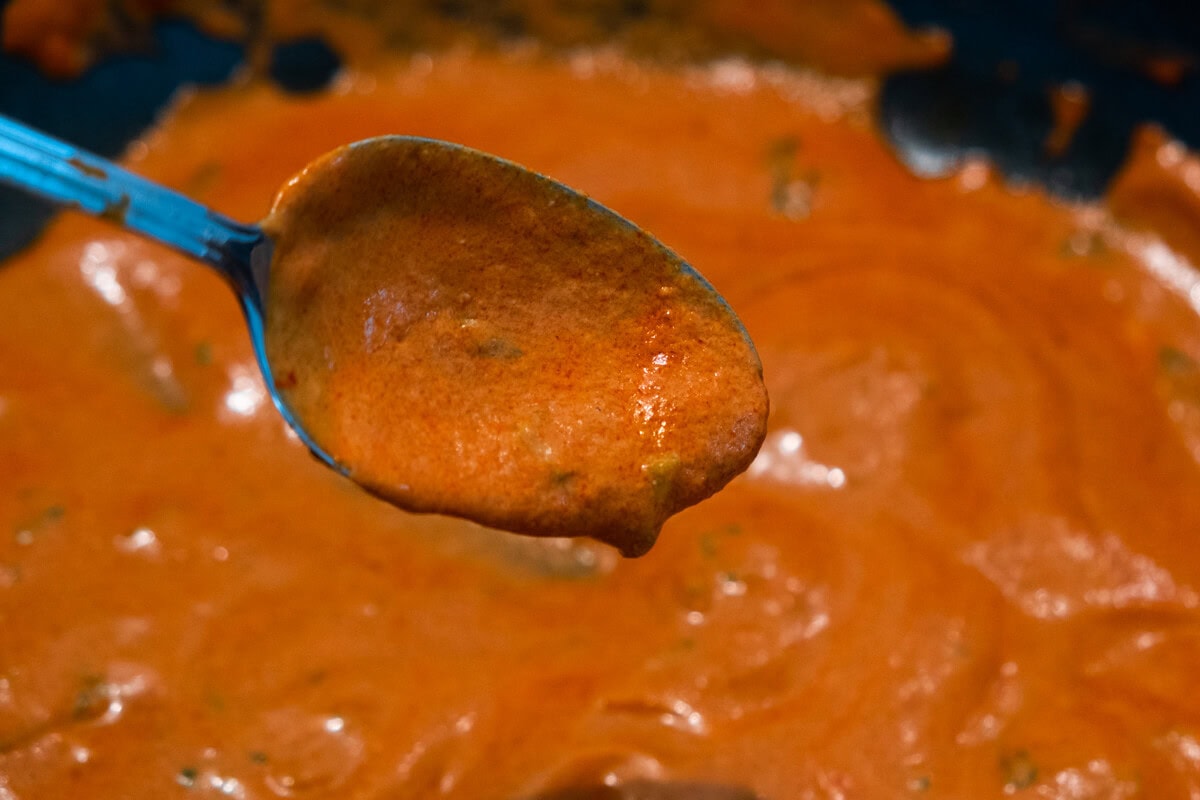 Making thick and creamy choo chee sauce in a pan. 