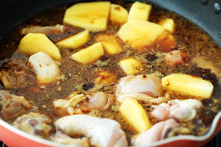 Baba Nyonya chicken and potatoes cooked in a pan. 