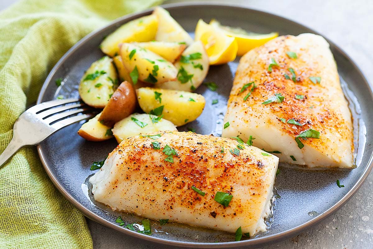 Fresh off the oven baked cod, served on a plate. 