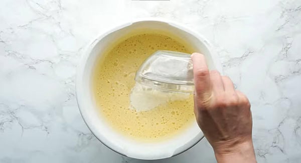 Adding the last part of flour into the cake mixture.