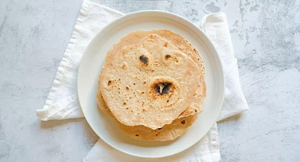 Cooked chapati on a plate.