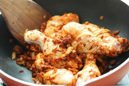 Chicken with curry in a pan. 