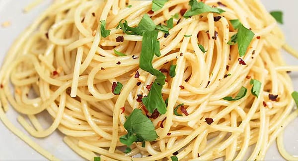 This image shows the Spaghetti being served on a plate.