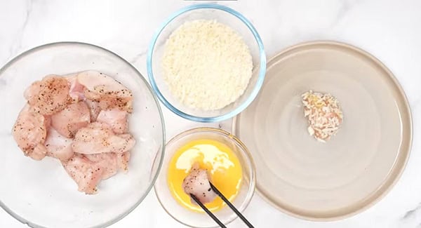 This image shows the chicken pieces being breaded with Panko.