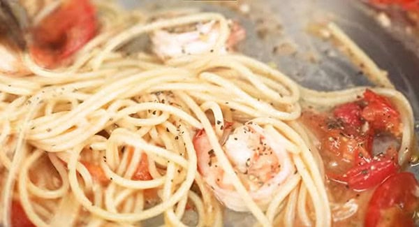 This image shows the Pasta being mixed with the other ingredients in the skillet.