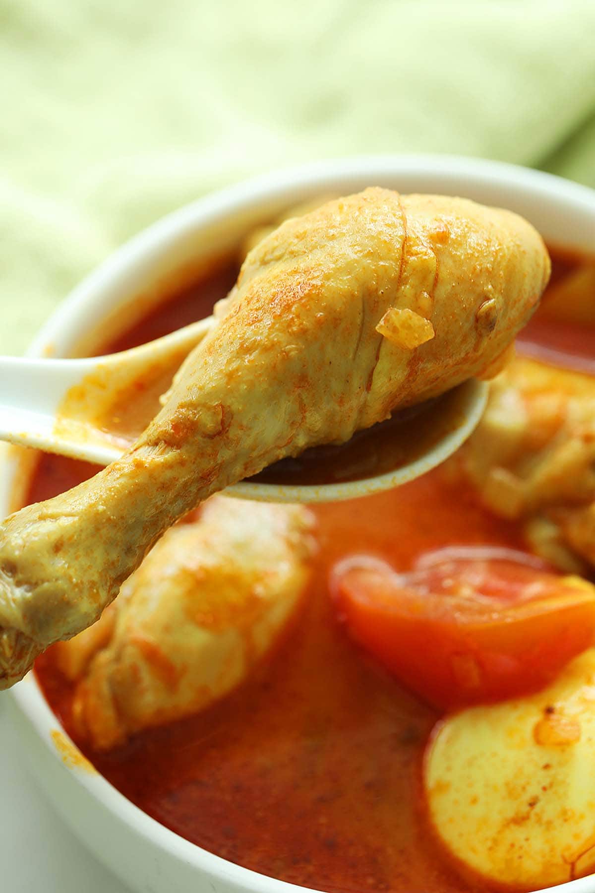 Malay-style kari ayam or chicken curry in bowl.