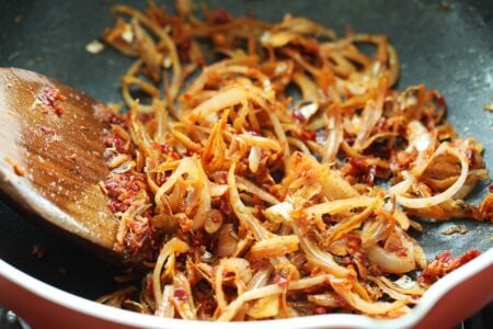 Making sambal anchovies in a pan. 