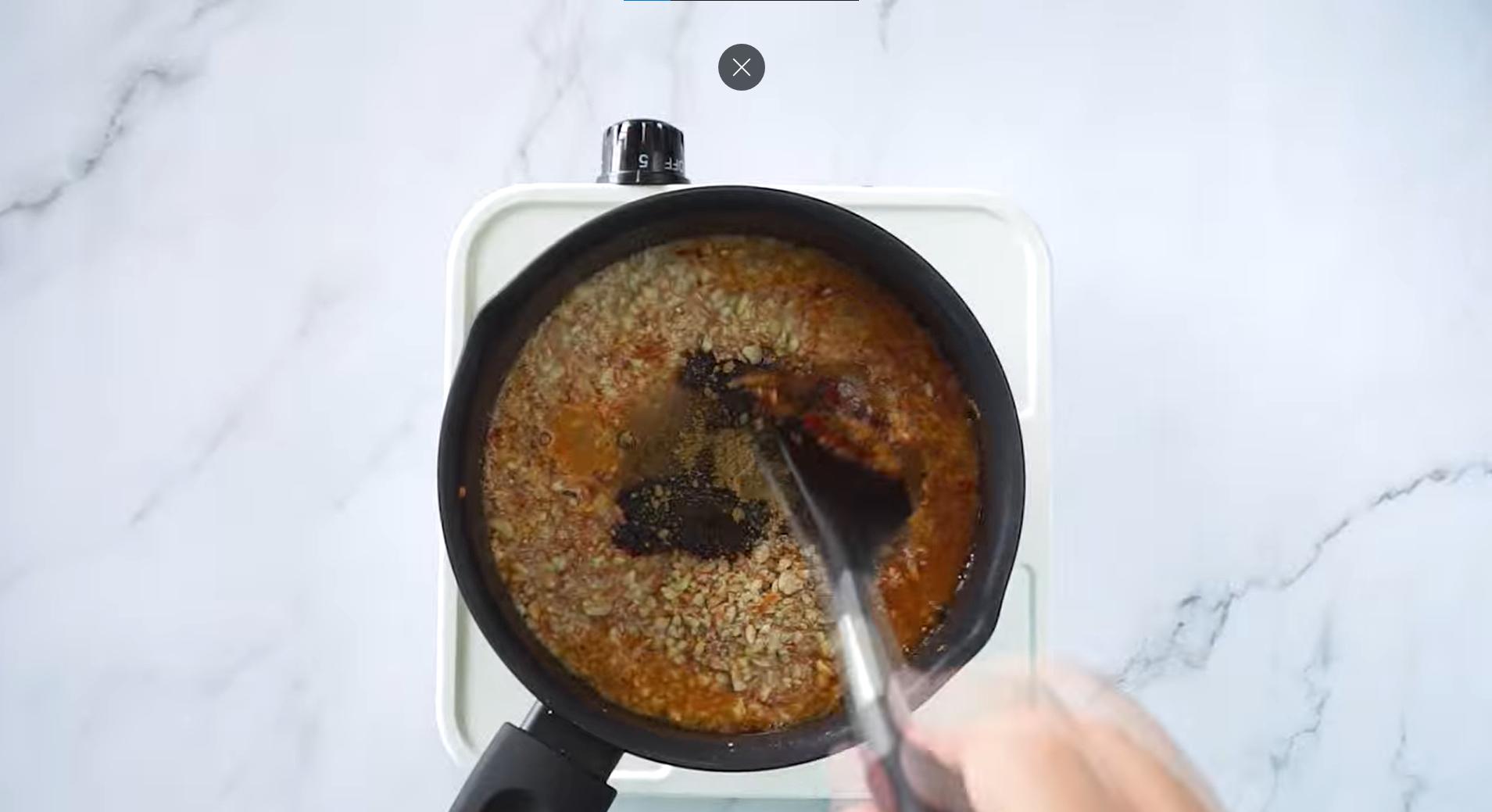 Ground peanuts, water, tamarind juice, salt, sugar, coriander powder and sweet soy sauce in a sauce pan with spice paste. 