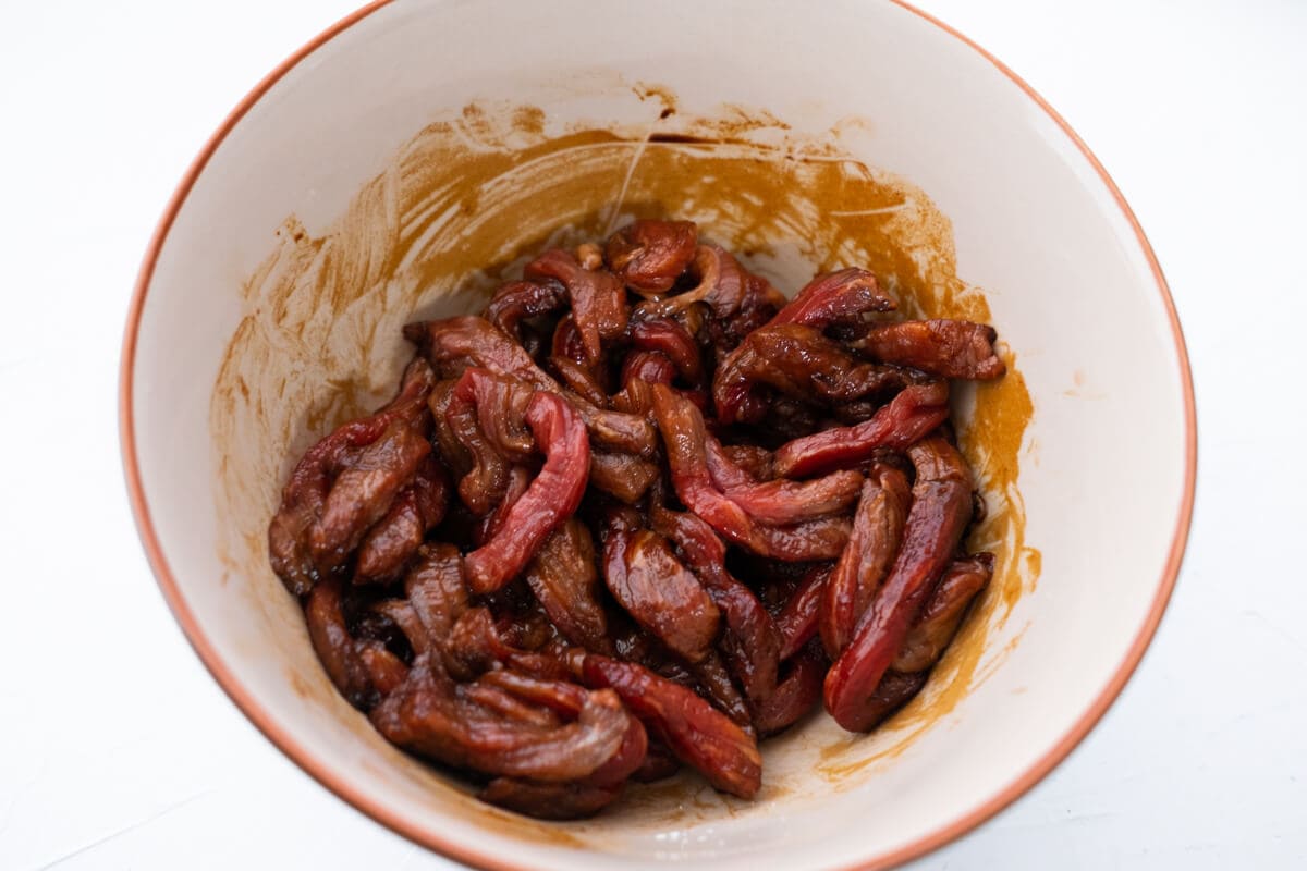 Marinate beef in a bowl. 