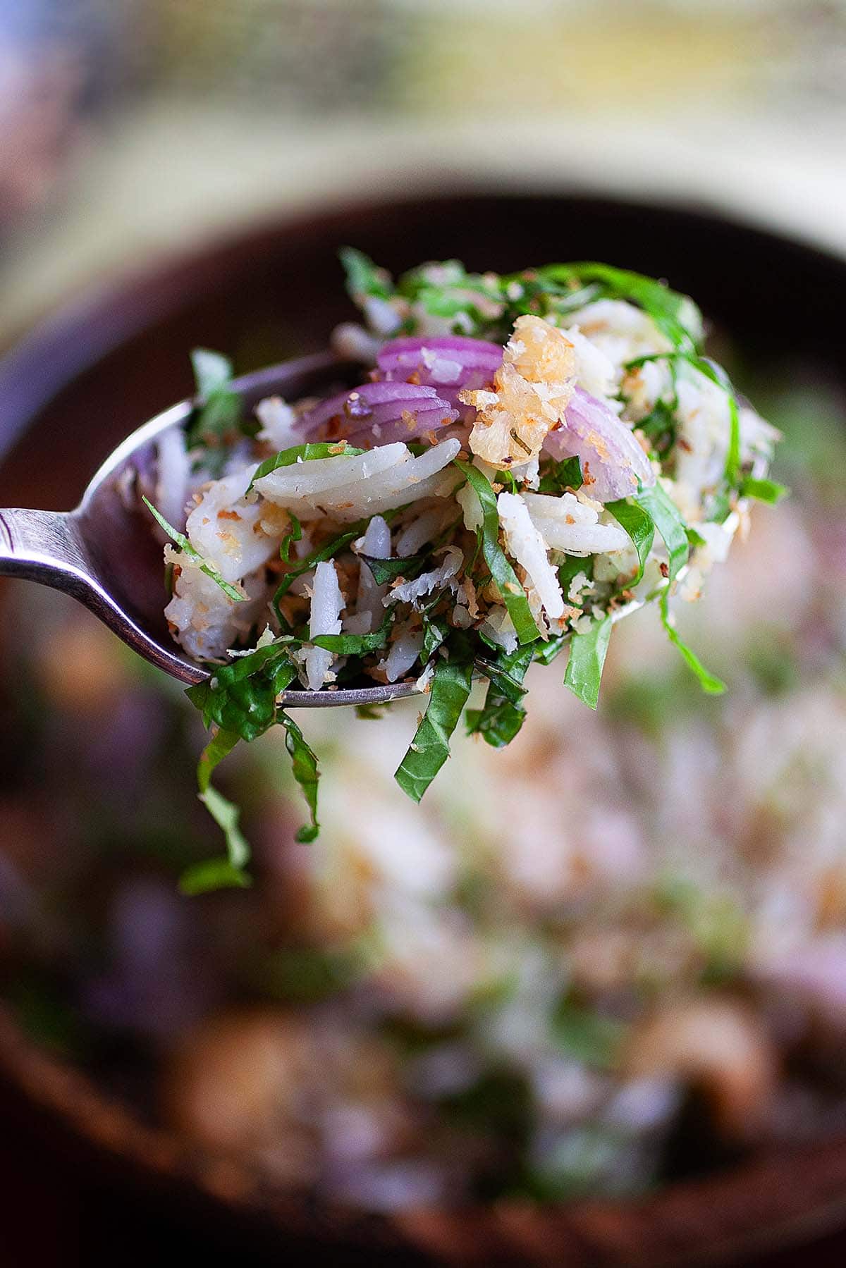 Nasi ulam on a spoon. 