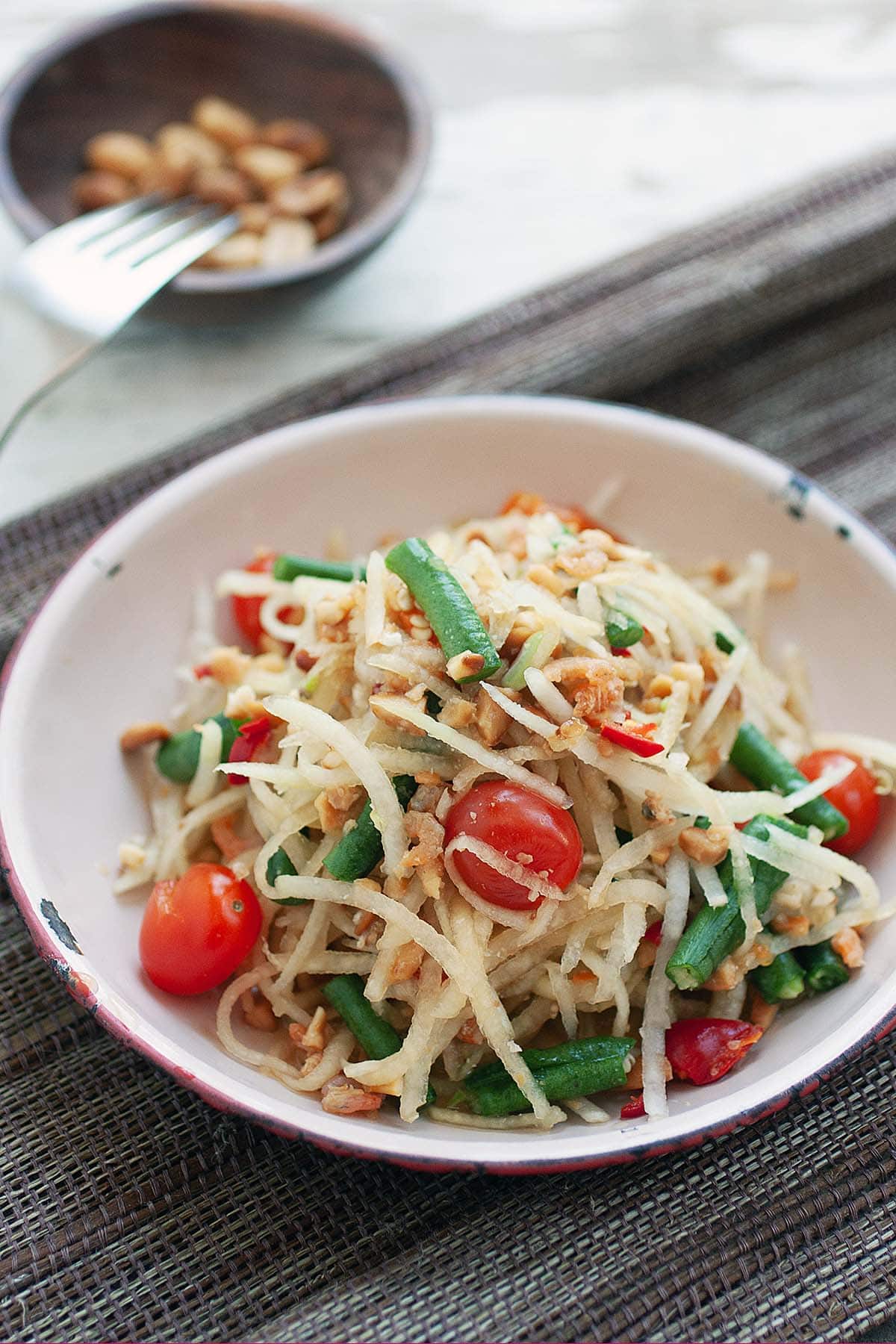 Green papaya salad with roasted peanuts as toppings. 