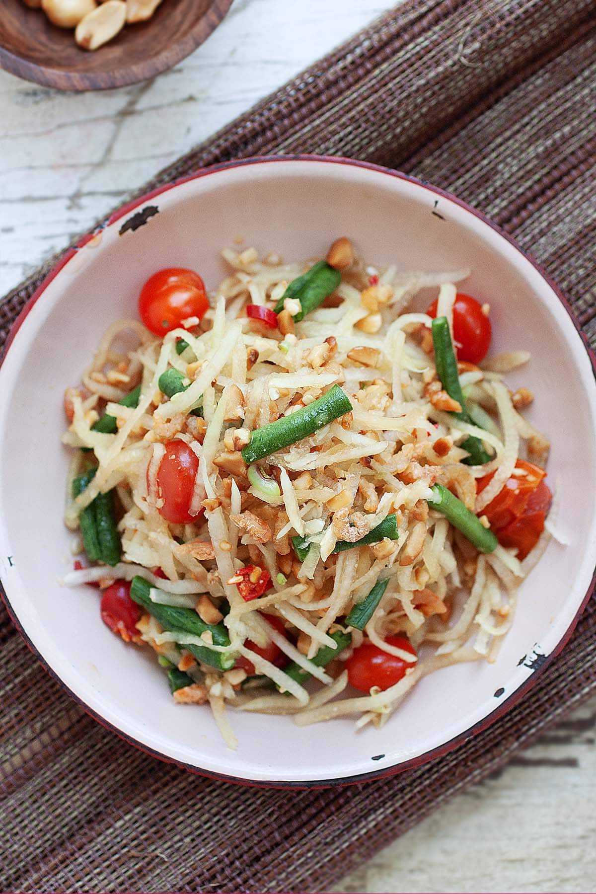 Green papaya salad served on a plate. 