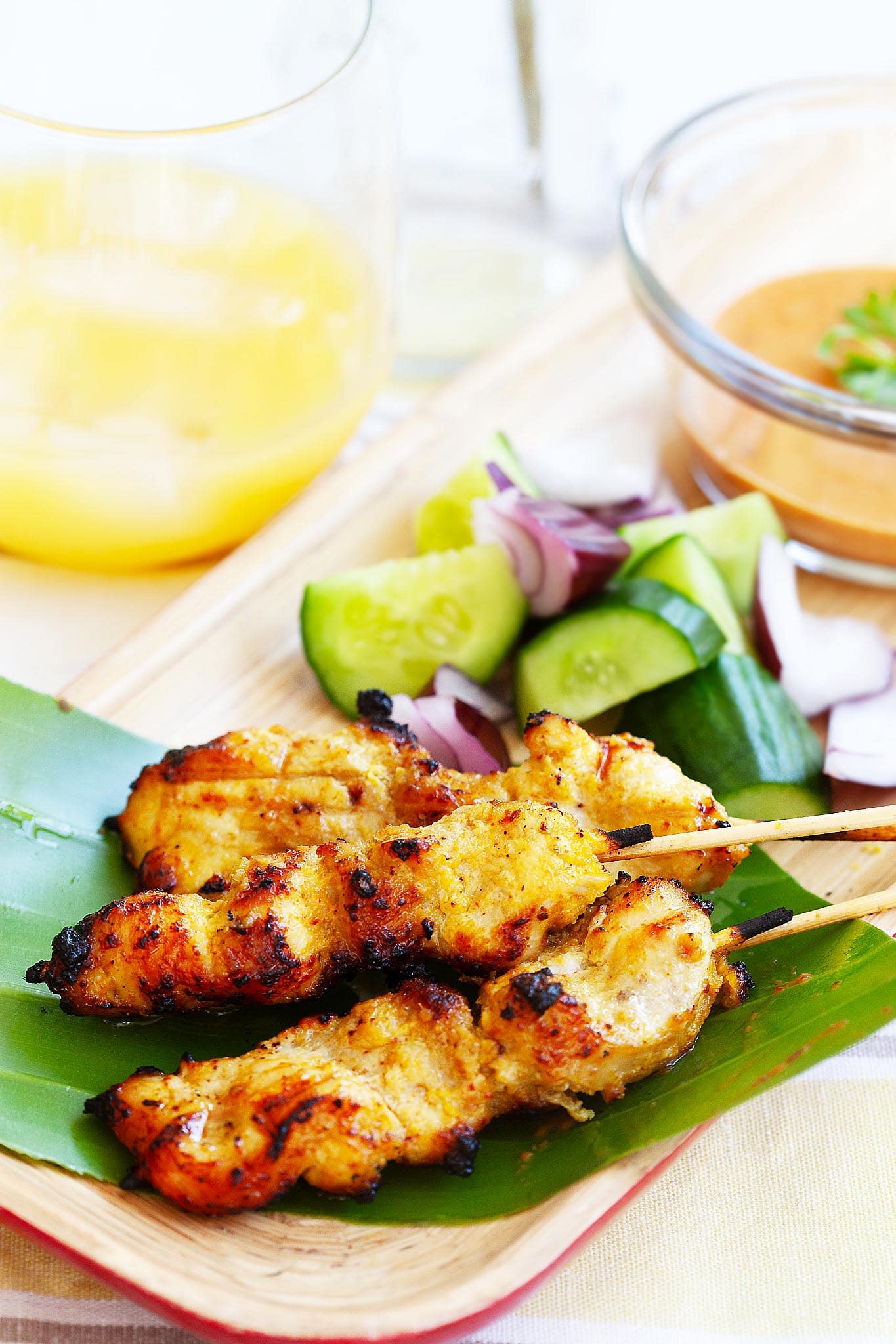 Thai chicken sate with peanut sauce served on a tray. 