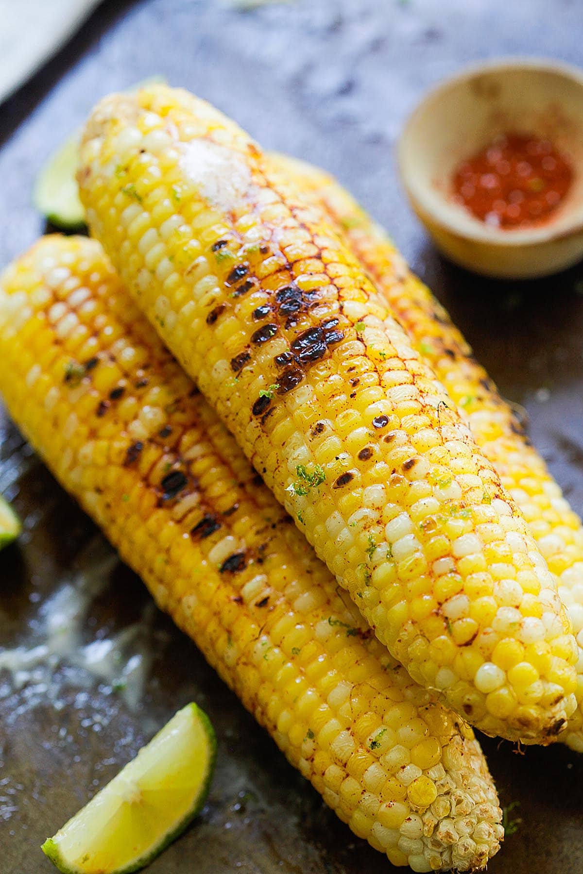 Chili lime corn on the cob served with lime wedges. 