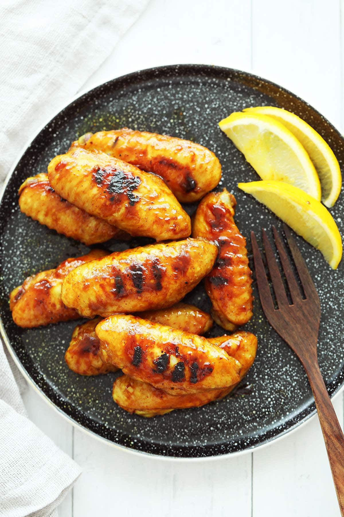 Honey wings with lemon wedges. 