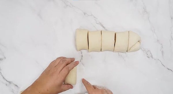 A piece of the dough is placed on a parchment paper. 