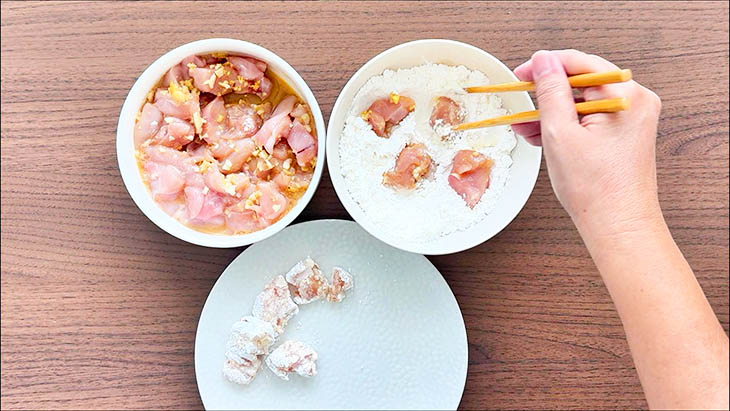 Chicken Breast being coated with cornstarch.