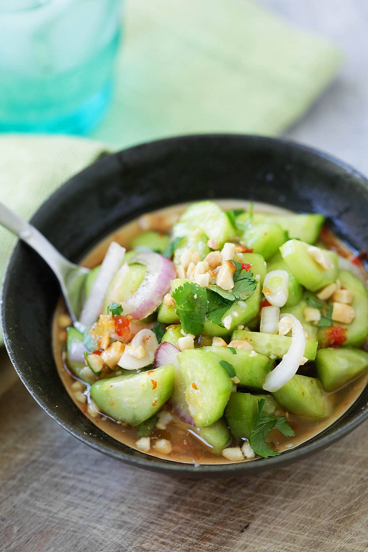 Easy Thai Cucumber Salad made with sugar, vinegar, peanuts, onions, cilantro in a spicy dressing. 