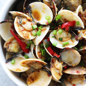 Easy and delicious stir fry Asian style clams with chili served in a plate.