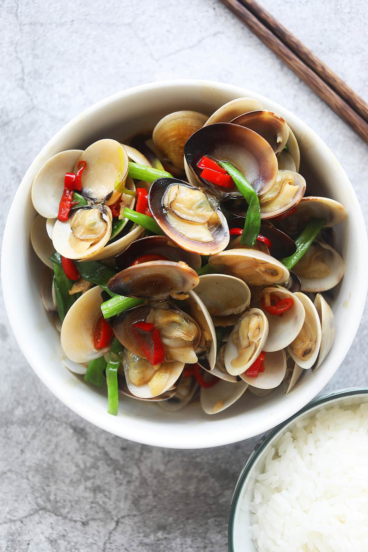 Chinese stir-fry clams with ginger, scallions, and red chilies in a savory brown sauce. 