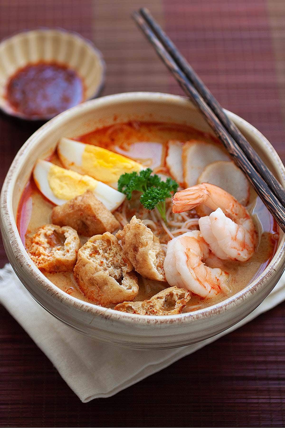 Curry noodle soup with shrimp, fish cakes, tofu puffs and hard-boiled egg. 