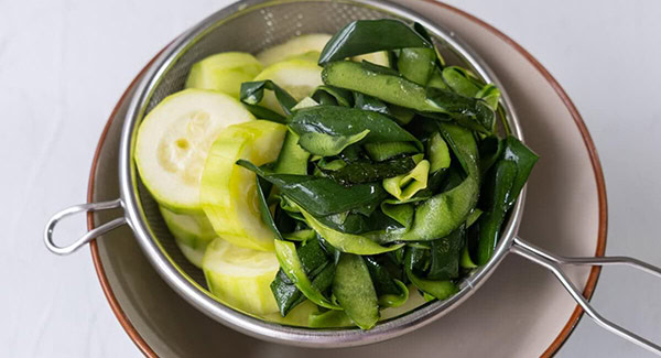 Placed the cooked zucchini and skin in a colander, sprinkle salt, and let drain. 