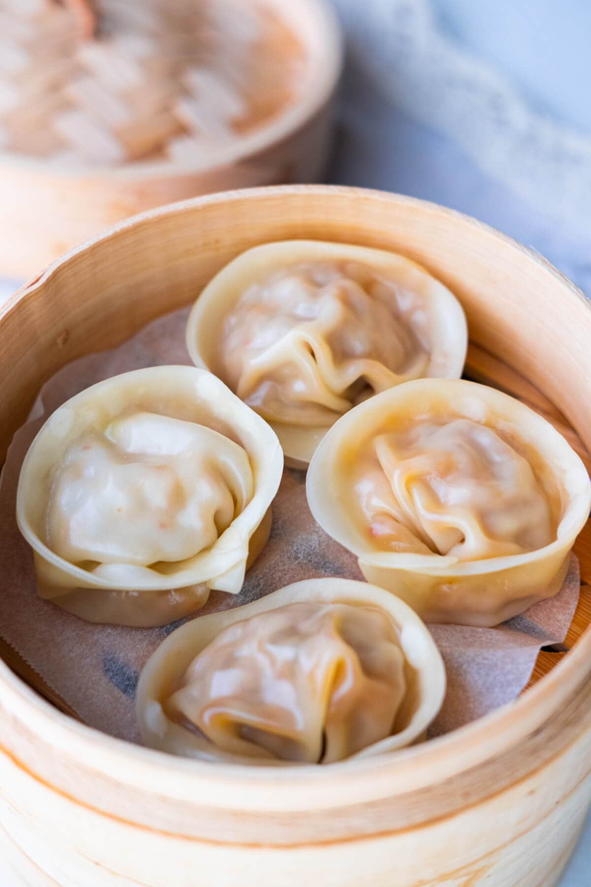 Korean dumplings (mandoo) served in a bamboo steamer. 