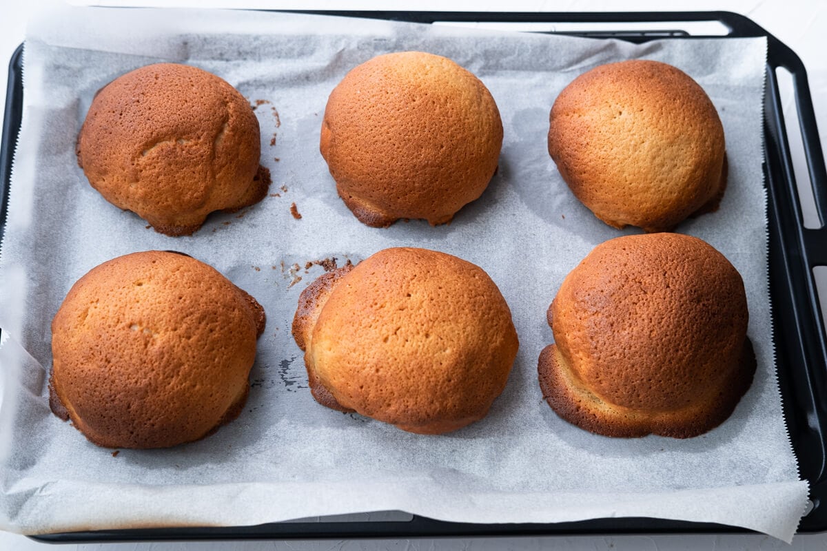 Baked Mexican coffee buns on a baking sheet lined with parchment paper. 