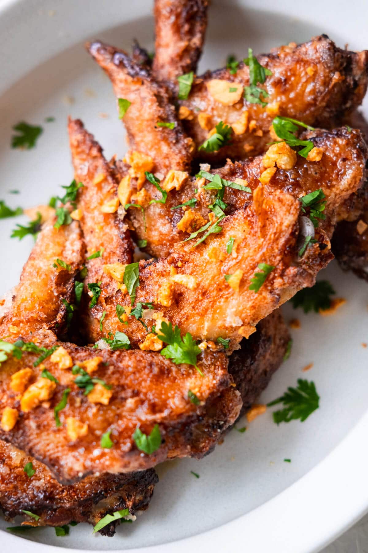 Vietnamese fish sauce wings topped with cilantro, mint, and fried garlic.