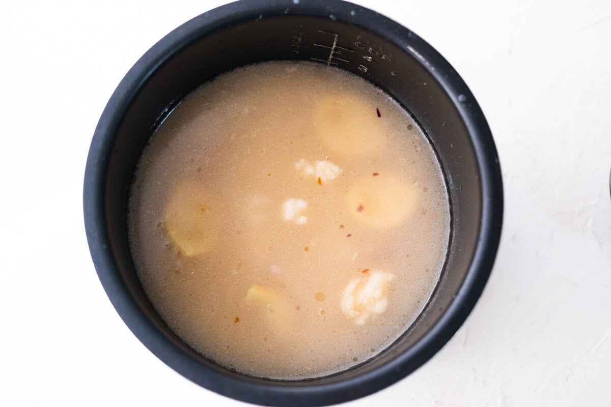 Transfer the rice, chicken broth, ginger, and chicken fat to the rice cooker. 