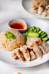 Hainan chicken rice served with cucumber and Hainan chicken.