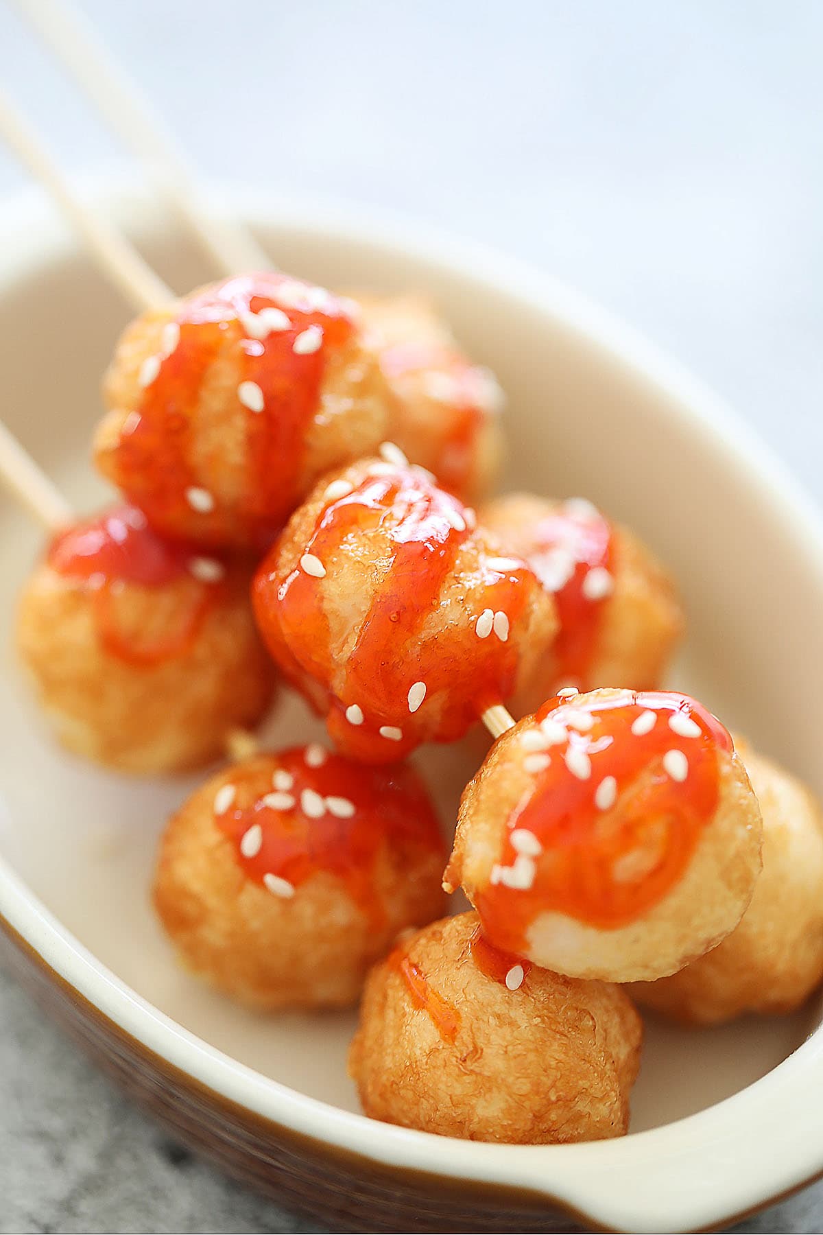 Fried cuttlefish balls threaded on a bamboo skewer.