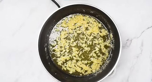 Garlic in melted butter in a skillet.