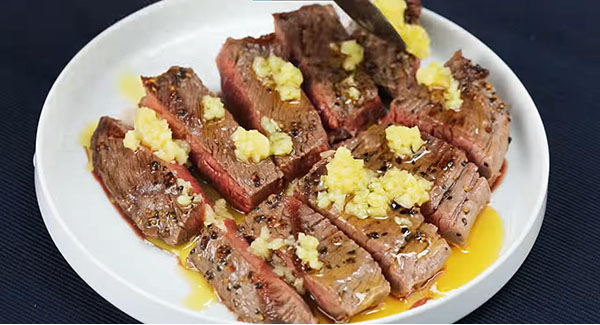 Garlic butter Brazilian steak served on a plate.