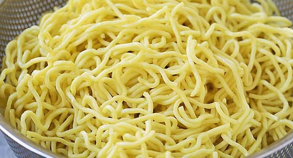 Taiwanese-style yellow oil noodles in a colander.