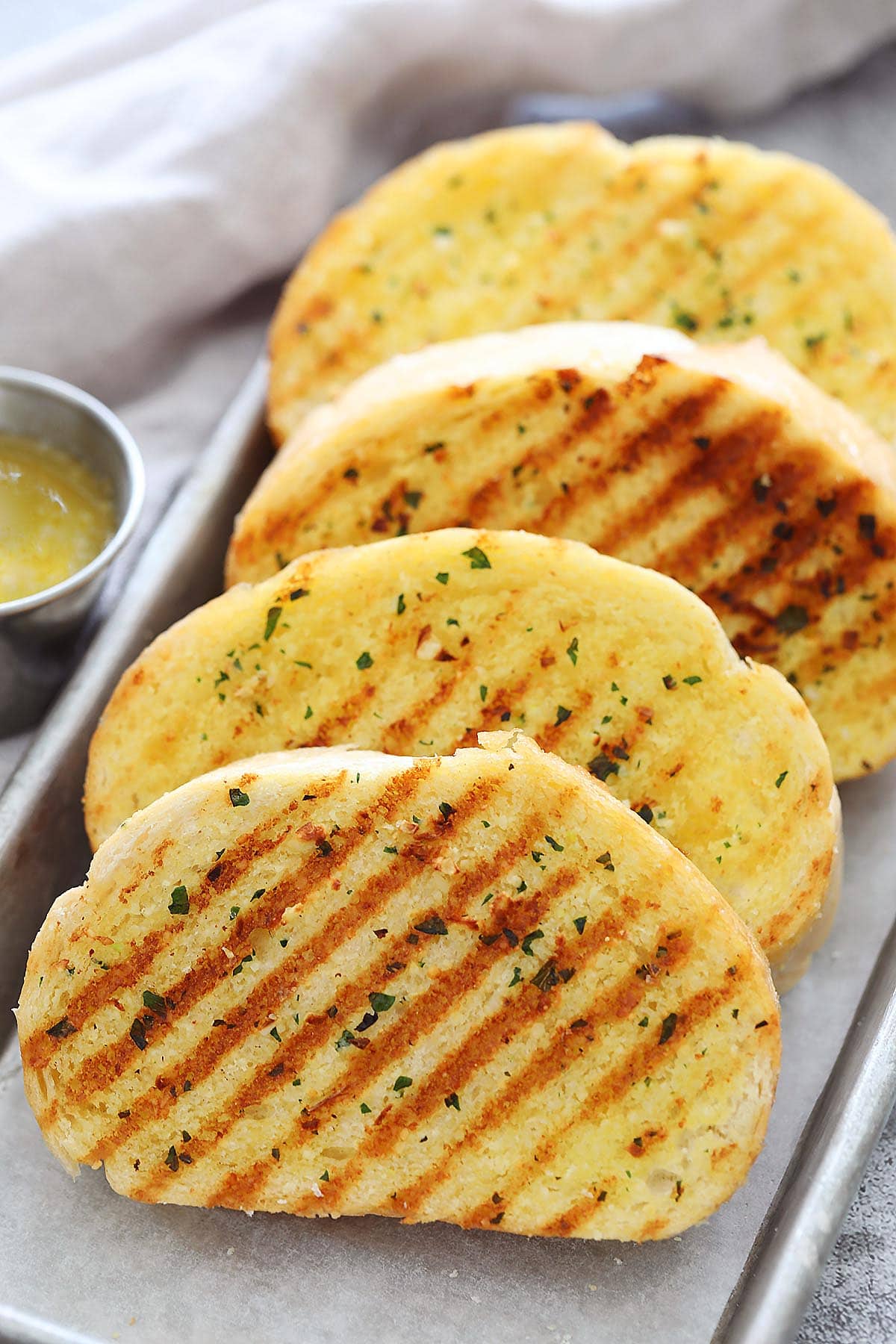 Slices of golden brown skillet garlic bread on a tray.