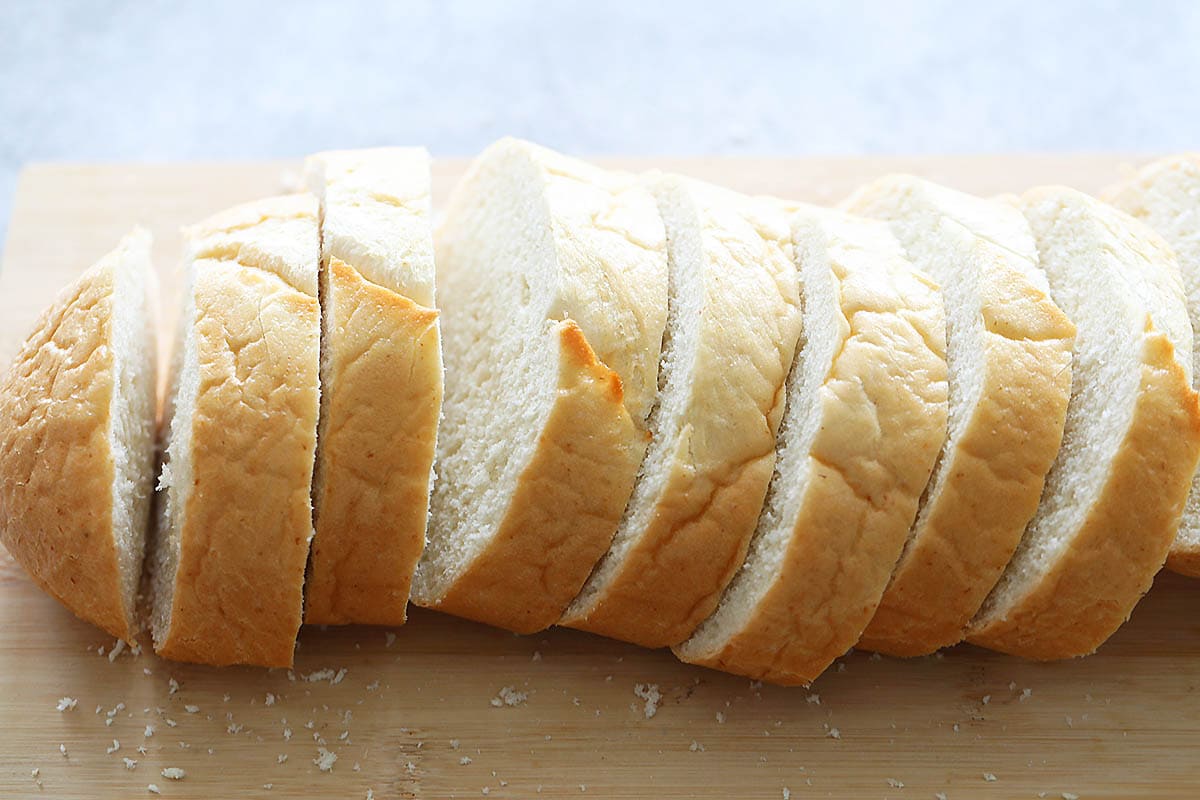 Slices of French bread on a chopping board.